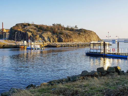 a body of water with a pier and an island at 7 person holiday home in STRöMSTAD-By Traum in Strömstad