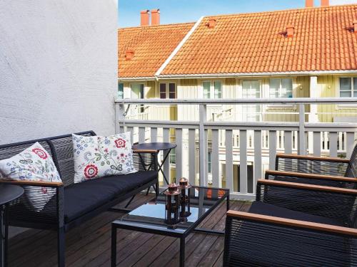 a patio with a couch and a table on a balcony at 7 person holiday home in STRöMSTAD-By Traum in Strömstad