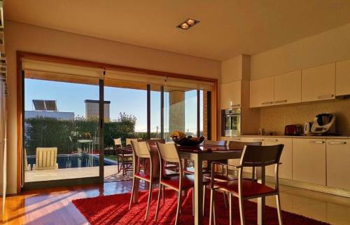 a kitchen and dining room with a table and chairs at Hill & Beach house in Viana do Castelo