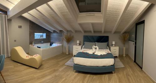 a bedroom with a bed and a tub in it at Miragredos in Mombeltrán