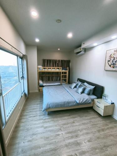 a bedroom with a bed and a large window at Harmony family room in Bangkok