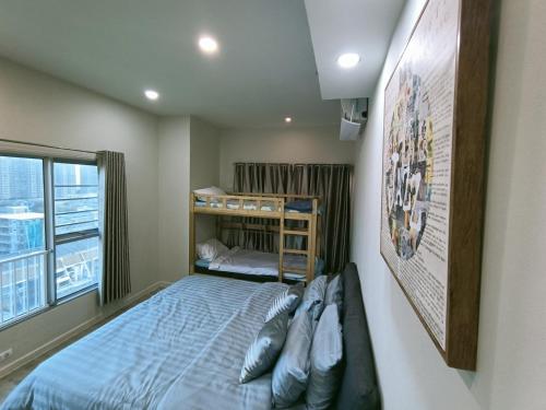 a small bedroom with a bunk bed and a window at Harmony family room in Bangkok