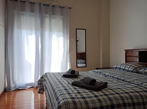 two beds in a bedroom with towels on them at Rooms in the apartment (Leontiou) in Athens