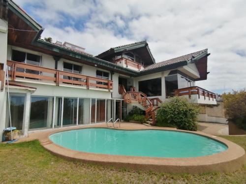 a house with a swimming pool in front of it at My Father's House Bed in Viña del Mar