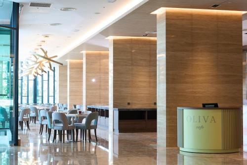 a dining room with tables and chairs in a building at Opero Hotel Southkey Johor Bahru in Johor Bahru