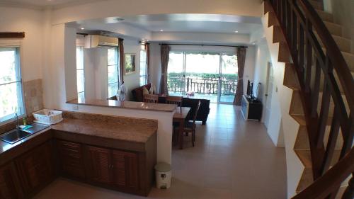 a kitchen with a counter and a dining room at Sea Lavender Villa in Ko Chang