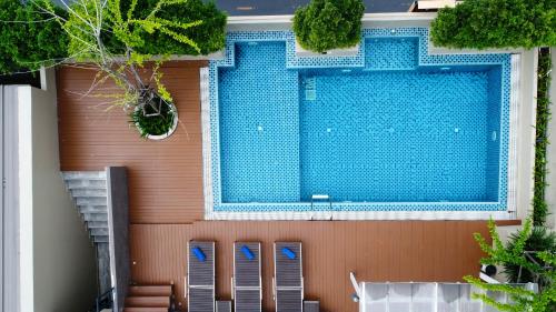 a swimming pool on the side of a house at Ramada Ekamai in Bangkok