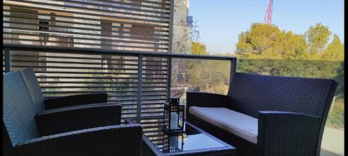 two chairs sitting on a balcony with a view at Paradise Village Port Aventuras in Salou
