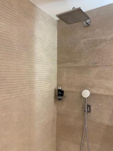a shower with a shower head in a bathroom at PALMSEA Marbella-Estepona in Buenas Noches