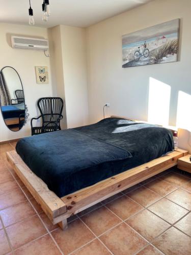 a bedroom with a large bed with a wooden frame at Casa rural Villa Aljambra in Albox