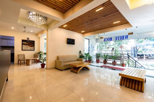 a lobby of a hospital with a couch and a table at Hotel White Rock By The Solitaire Hospitality in Dehradun