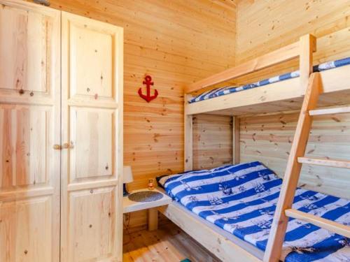 a bedroom with two bunk beds in a wooden cabin at Domki Letniskowe Słoneczna Przystań in Ustka