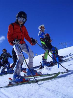 a group of people skiing down a snow covered slope at Albergo Stelvio in Bormio