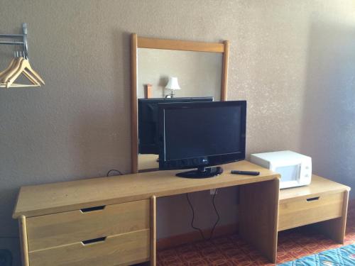 a desk with a computer monitor on it in a hotel room at Lake Shore Motel in Mannford