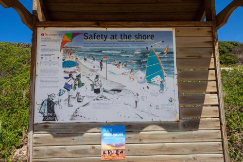 a sign for the beach at the shore at Long Story Guest House in Plettenberg Bay