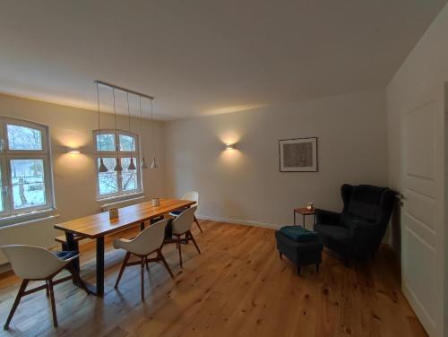 a living room with a dining room table and chairs at Forsthaus Zartwitzer Hütte in Rechlin