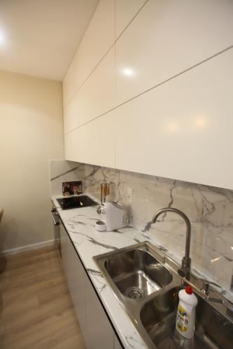 a kitchen with a sink and a counter top at Arkle Apartment 1 in Tirana
