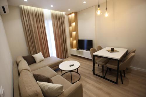 a living room with a couch and a table at Arkle Apartment 1 in Tirana