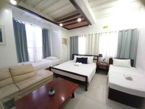 a living room with two beds and a couch at SOFIATEL Rooms in Santa Maria