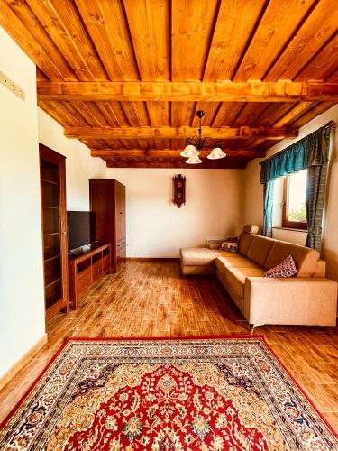 a living room with a couch and a rug at Csigevár Birtok in Balatonendréd