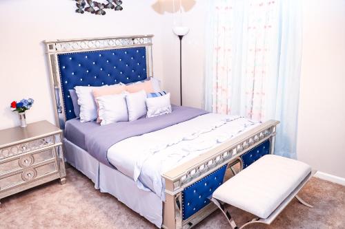 a bedroom with a blue bed and a chair at Luxury 3b,2bts Loft Apt of a House Near shops in Lithonia