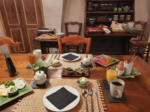 a wooden table with plates of food on it at La Maison Provençale in La Roquebrussanne