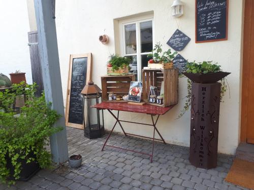 a table in front of a window with plants on it at Landhaus Gräfendhron in Gräfendhron