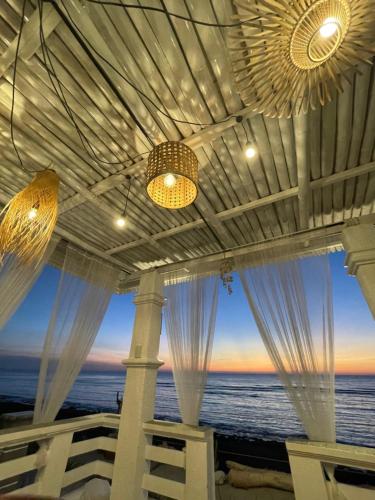 a view of the ocean from a beach house at REEF HOUSE BACNOTAN White sand beach front with Private Swimming pool in Bacnotan