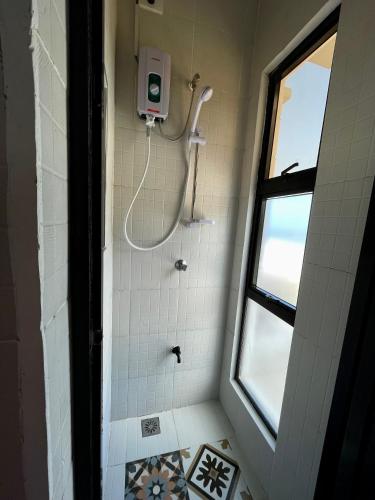 a shower in a bathroom with a window at REEF HOUSE BACNOTAN White sand beach front with Private Swimming pool in Bacnotan