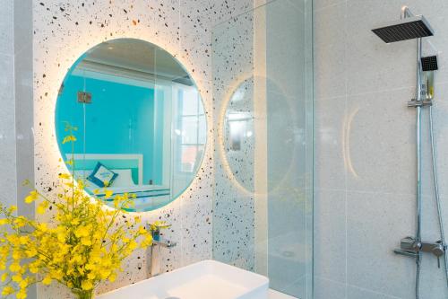 a bathroom with a mirror and a sink at La Casa Boutique Hotel in Vung Tau