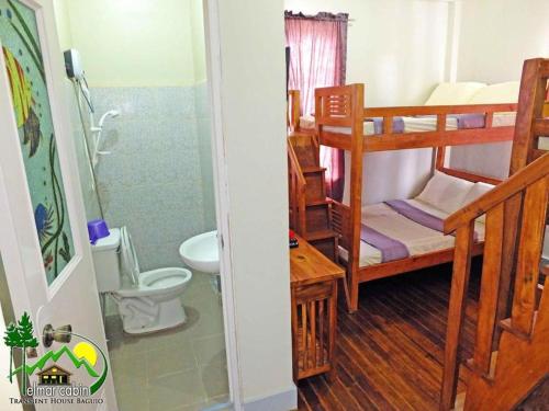 a room with a bathroom with a toilet and a shower at Elmar Cabin in Baguio