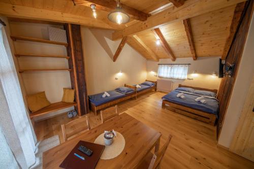 an overhead view of a room with bunk beds and a table at Apartment Ve Mlýně in Teplice nad Metují