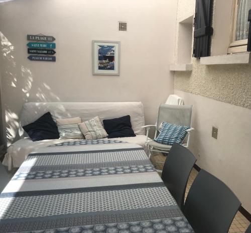 - deux tables et un canapé dans une chambre dans l'établissement Maison de vacances Arzaël à 200m de la plage célèbre de Mr Hulot, à Saint-Nazaire