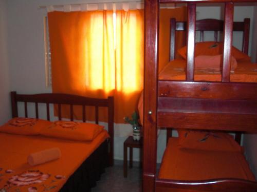 a bedroom with two bunk beds and a table at Pousada Sol Nascente in Olímpia