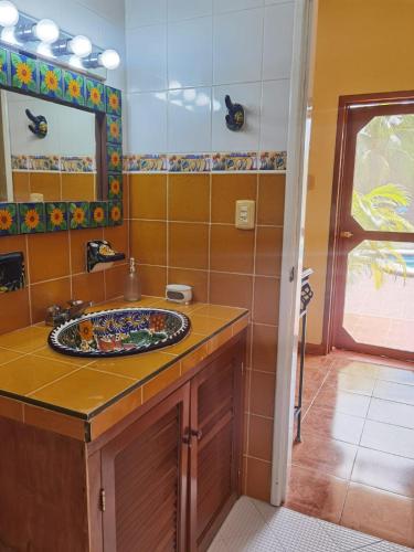 a bathroom with a sink and a mirror at Paradise Ranch in Cozumel