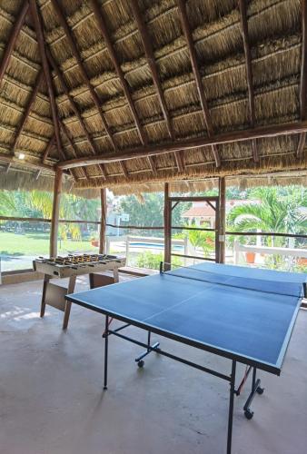a ping pong table sitting inside of a building with a table at Paradise Ranch in Cozumel