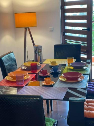 a dining room table with plates and dishes on it at PANTELI APART HOUSE in Aheloy