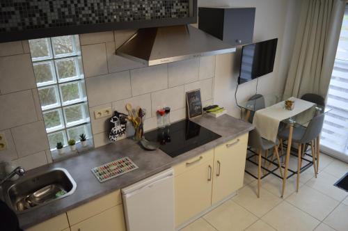 a kitchen with a sink and a counter top at La Lunadeléo in Wépion