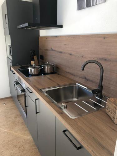 a kitchen with a stainless steel sink and a counter at Ferienwohnung Familie Zint in Sonthofen