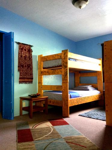 a bedroom with two bunk beds and a table at Kalani Hawaii Private Lodging in Pupukea