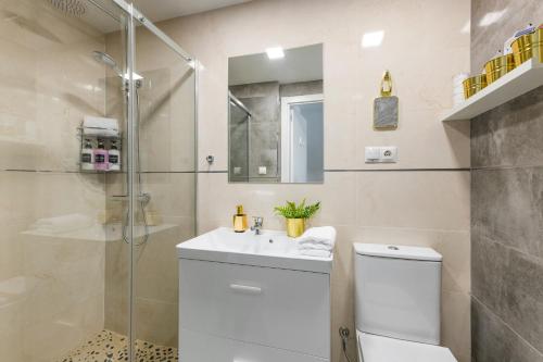 a bathroom with a toilet and a sink and a shower at SWEET DREAMS APARTMENT NEAR PUERTA DEL SOL in Madrid