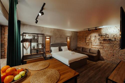 a room with a bed and a table with fruit on it at Квартира студия в центре Оскар in Petropavlovsk