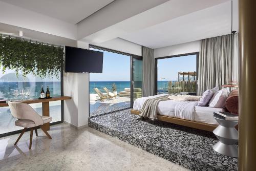 a bedroom with a bed and a view of the ocean at Dyo Suites in Rethymno