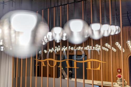 a bunch of chandeliers hanging from the ceiling at HOTEL AGAPE in Bar