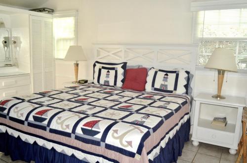 a bedroom with a bed and two pillows at Cottages by the Ocean in Pompano Beach