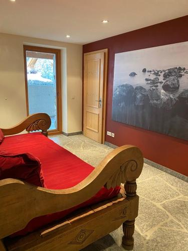 a bedroom with a large wooden bed with a red blanket at ClubHotel Hinterthal Am Florysee 13 in Hinterthal