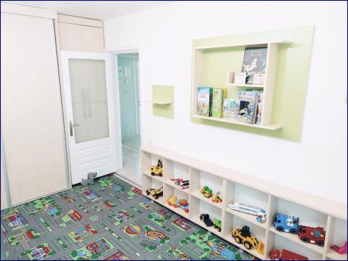een kinderkamer met een lego-tapijt op de vloer bij Smart Apartament in Piatra Neamţ