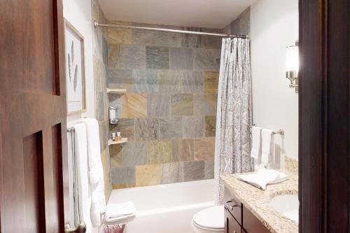 a bathroom with a shower and a toilet and a sink at Beaver Creek West G3 in Beaver Creek