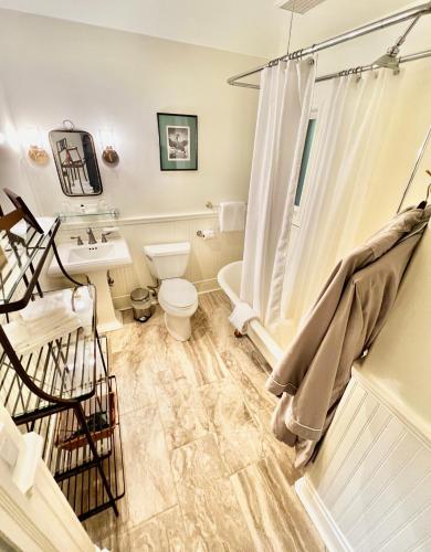 a bathroom with a toilet and a sink and a shower at Otter's Pond Bed and Breakfast in Eastsound