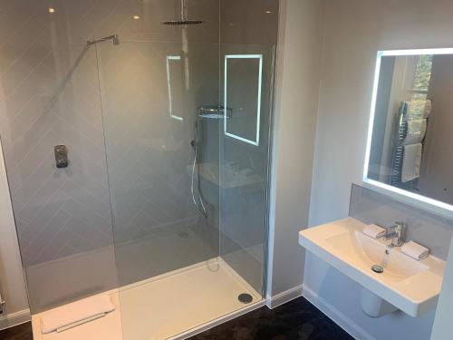 a bathroom with a shower and a sink at The Parklands Hotel in Perth